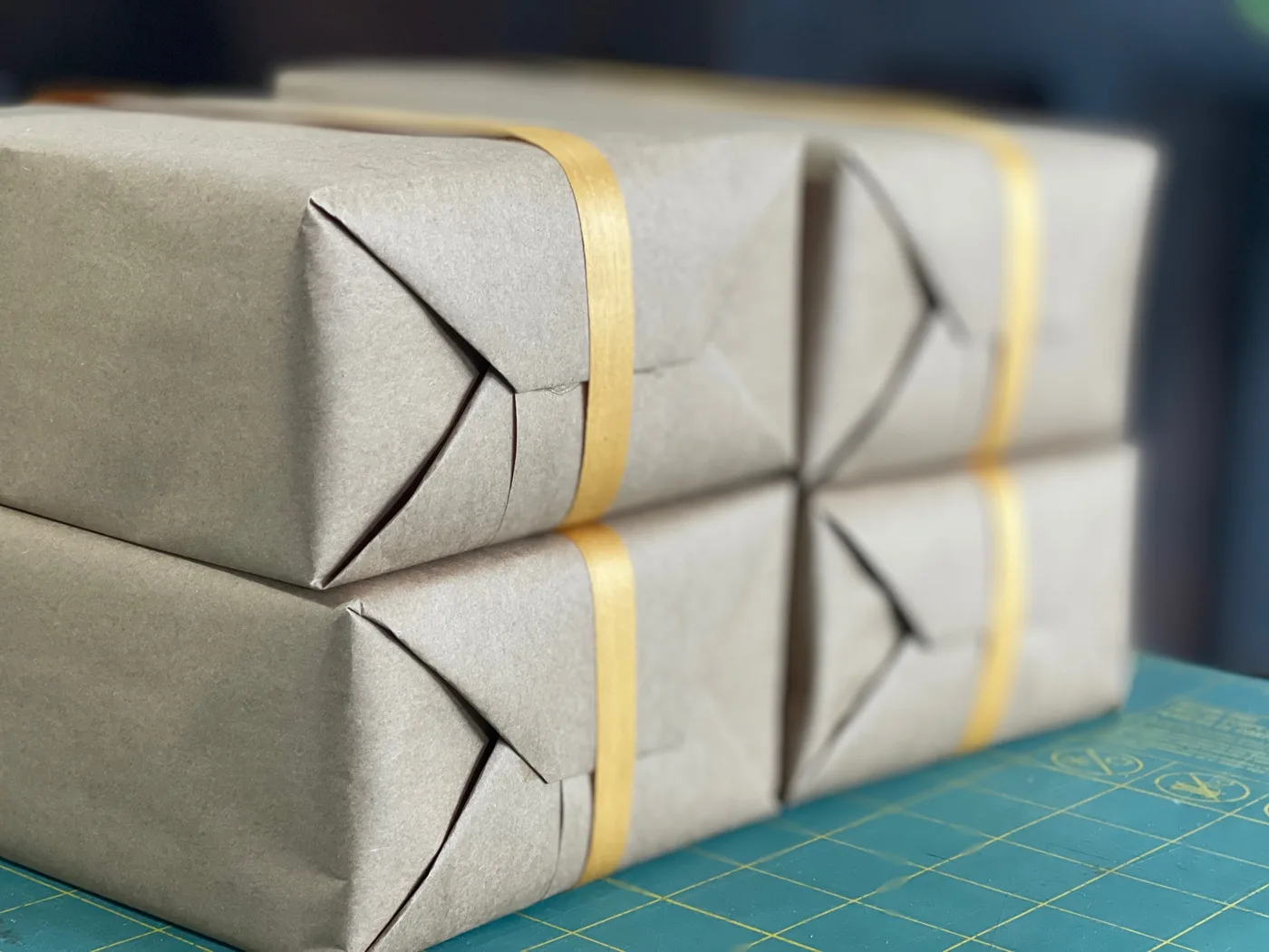 Letterpress prints wrapped in kraft paper and tied with ribbon, ready to ship