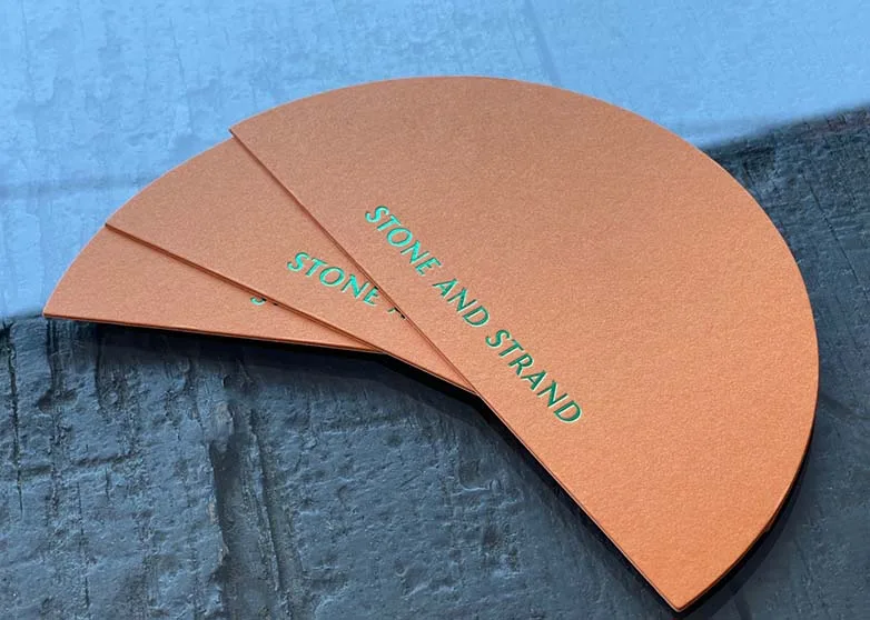 Arch-shaped die cut letterpress card on a neutral background