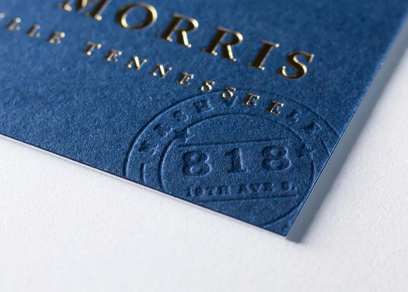 Close-up of a deep letterpress impression pressed into cotton paper