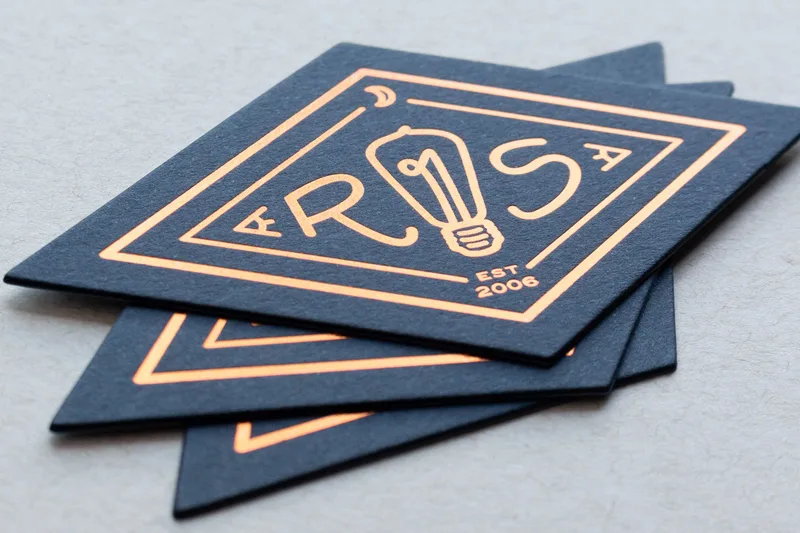 Diamond-shaped die-cut letterpress business card with copper foil stamping