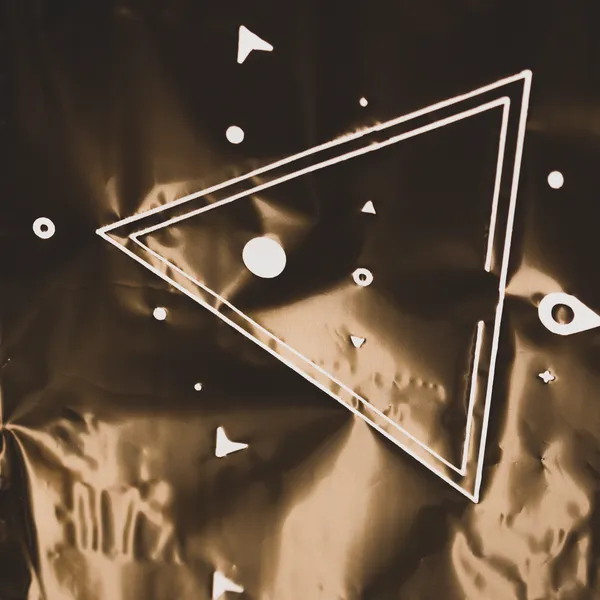 Freshly foil stamped art print sitting on the press with copper foil curtain behind