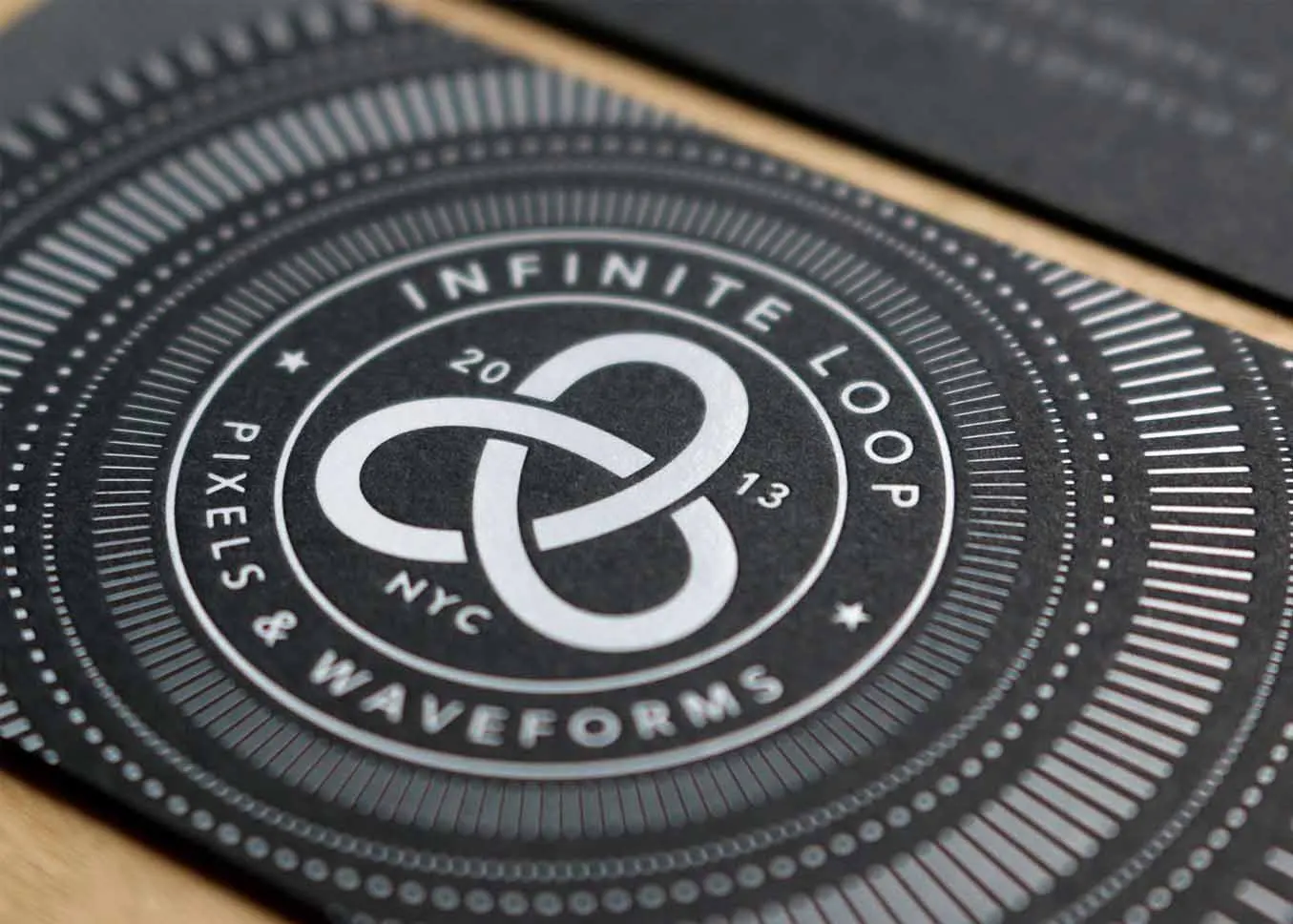 White foil stamped business cards on Classic Crest Epic Black paper
