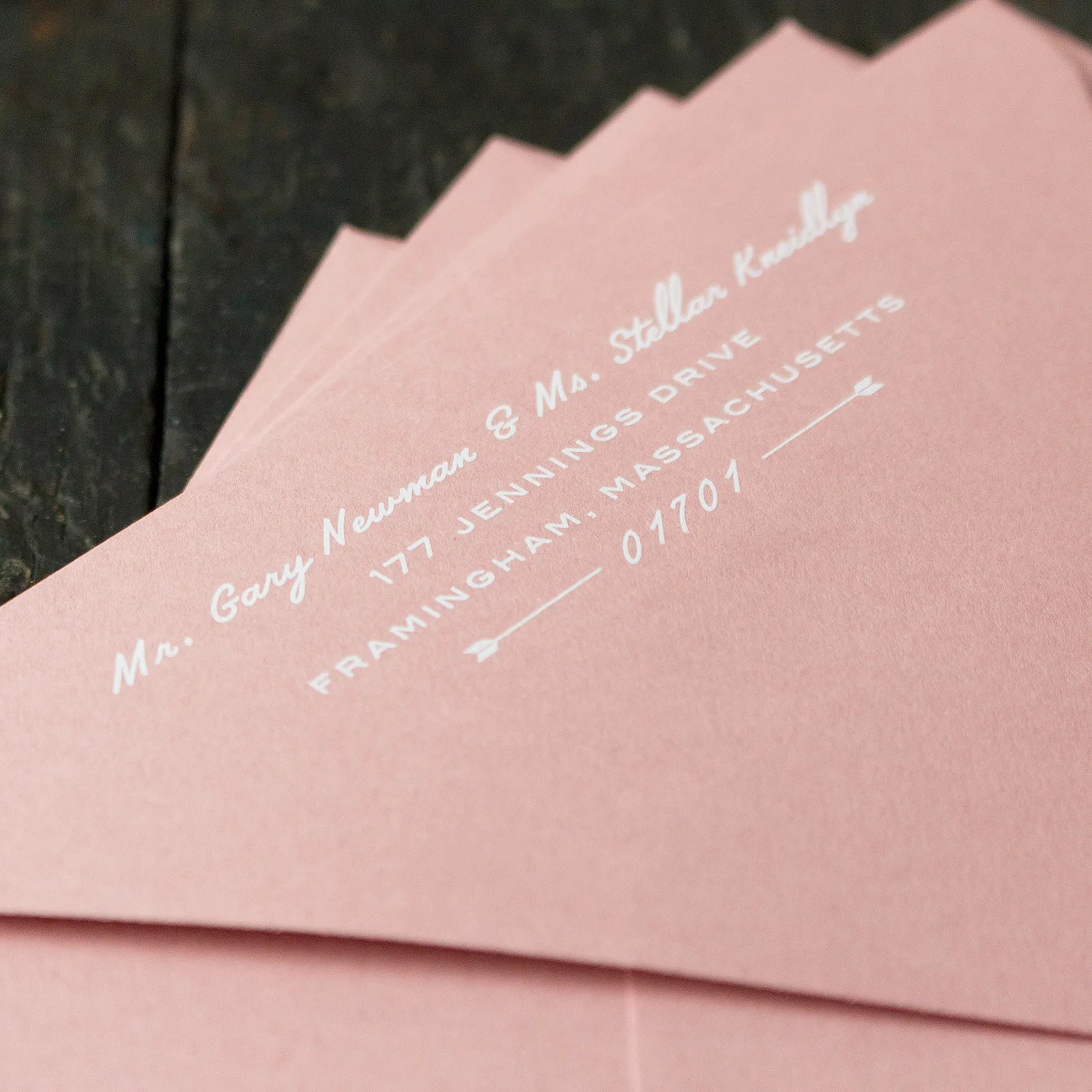 White ink address printed on a dark envelope