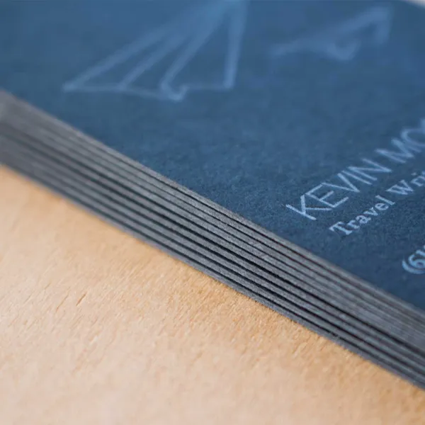 Black paper letterpress business card stacked with silver ink printing