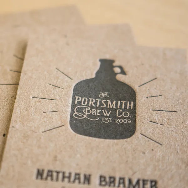 Chipboard letterpress business card for a craft brewery with a growler illustration in black ink