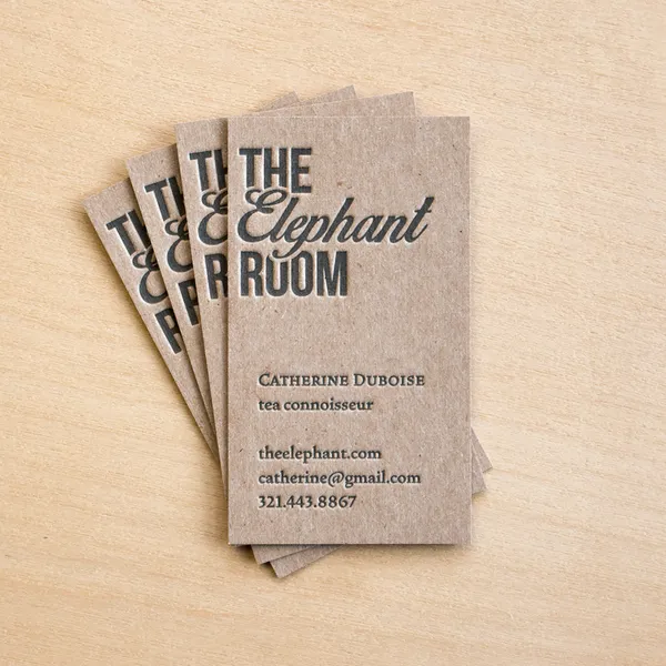 Overview of several chipboard letterpress business card designs printed in black ink on recycled board