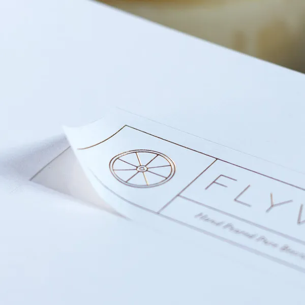 Foil stamped adhesive label for a candle jar