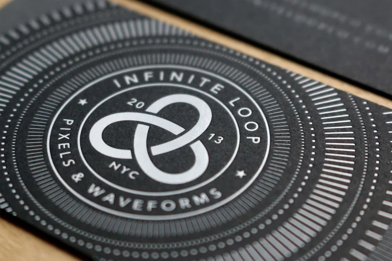 White foil on black paper business card