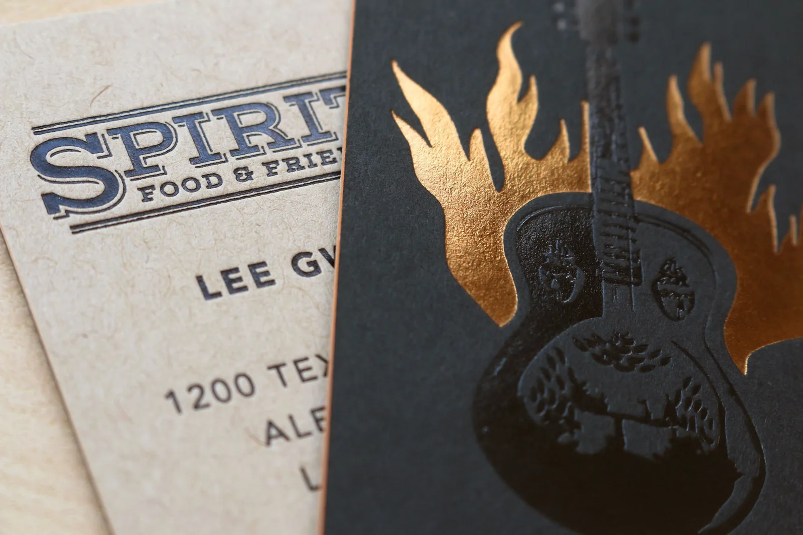 Quadplexed black business card with copper foil stamping for a spirits brand