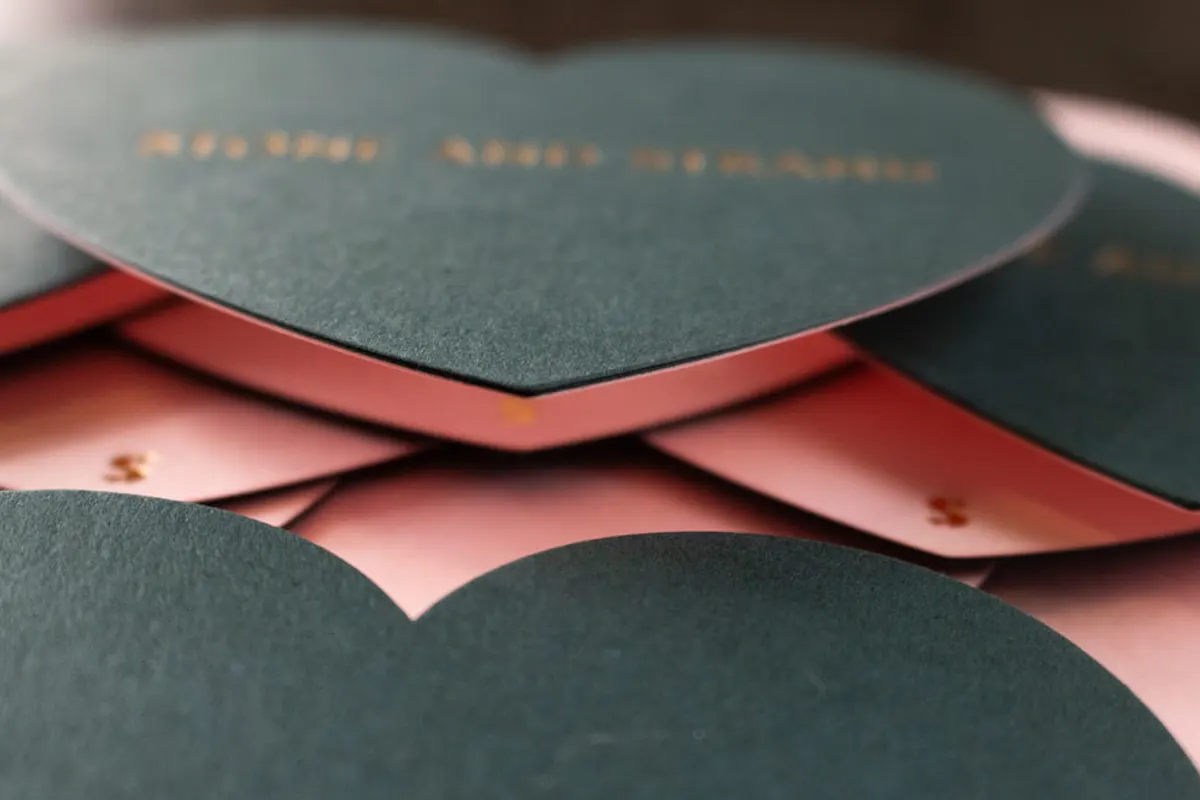 Edge detail of duplexed heart note card showing two contrasting paper colors bonded together