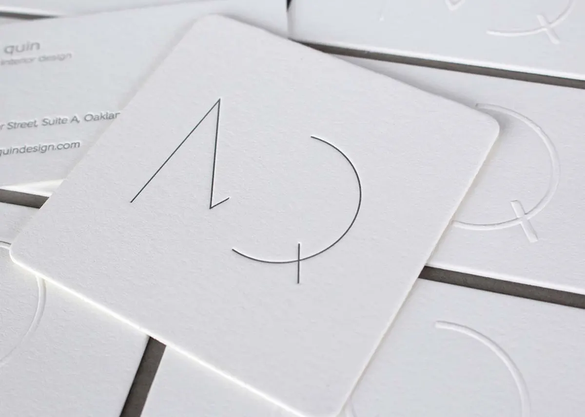 Close-up of a deep blind-embossed letterpress impression on cream cotton paper