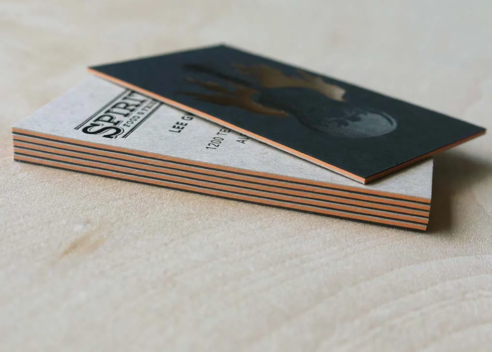 Copper foil stamping detail on black letterpress business card