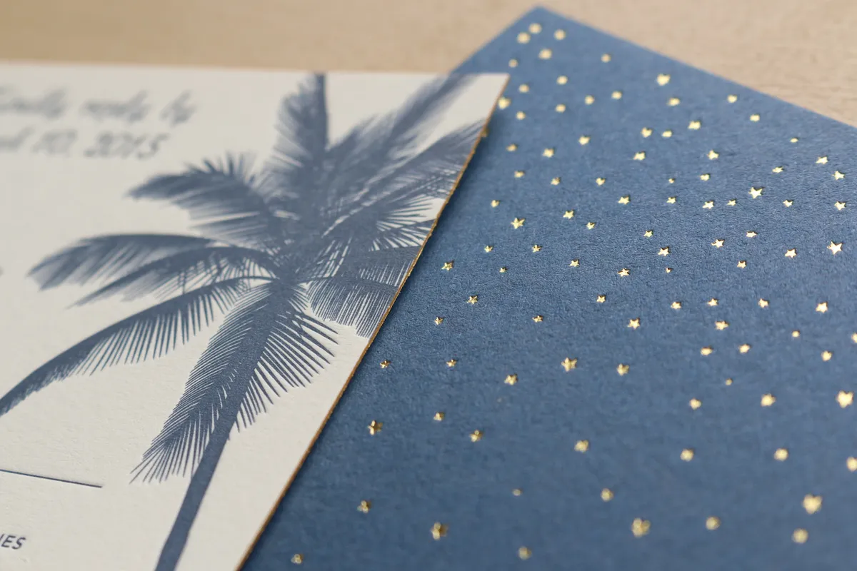 Macro detail of tiny gold foil stars stamped across deep blue Colorplan Cobalt cover stock